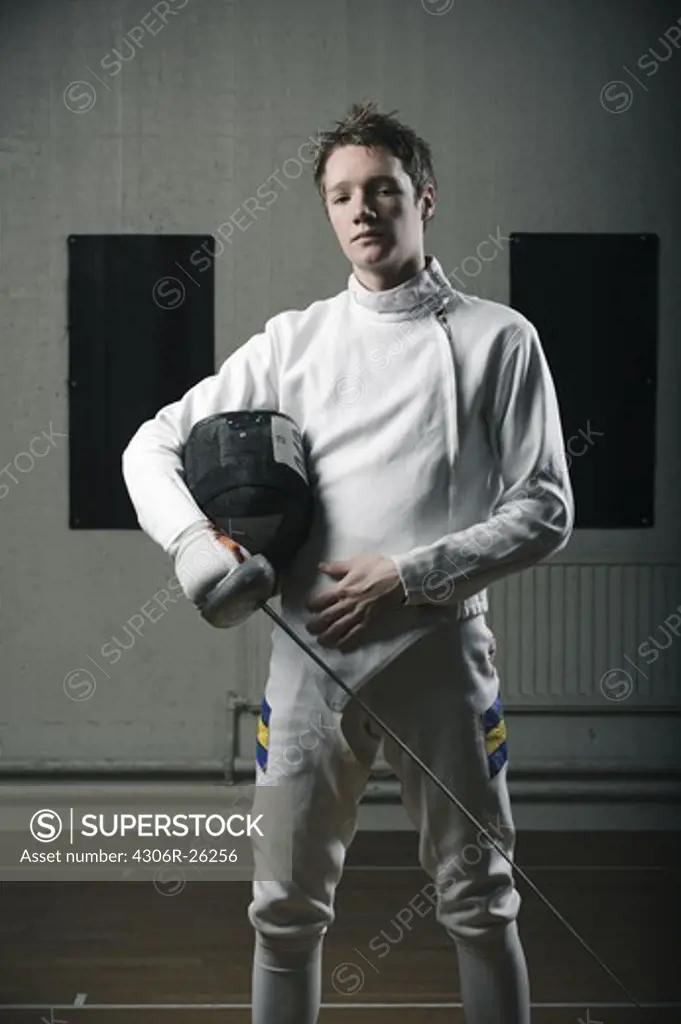 Portrait of male fencer in sports hall