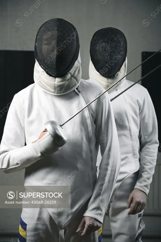 Portrait of two fencers holding fencing foils