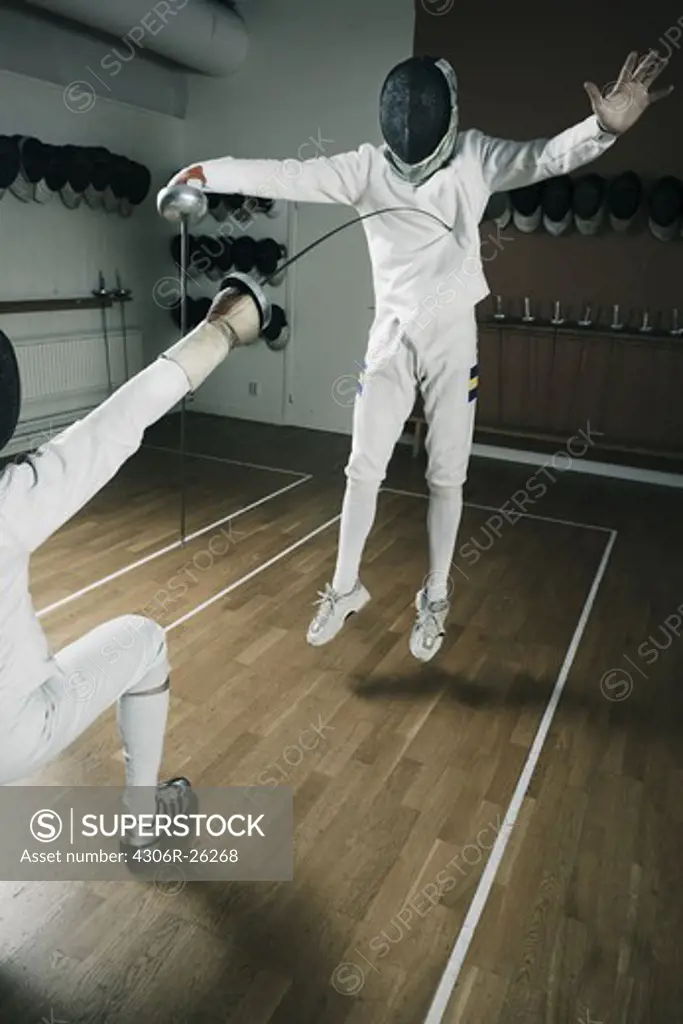 Two fencers in sports hall