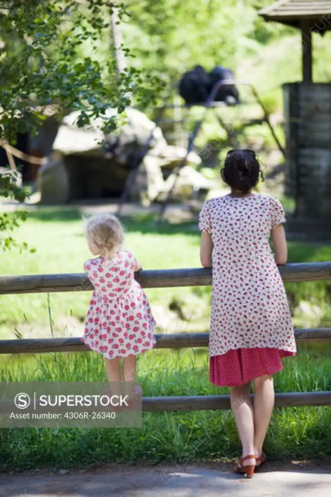 Mother and daughter watching animals at zoo