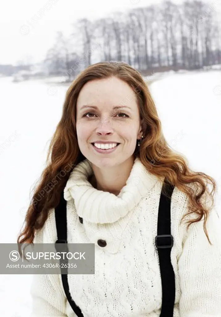 Portrait of woman in snow covered field