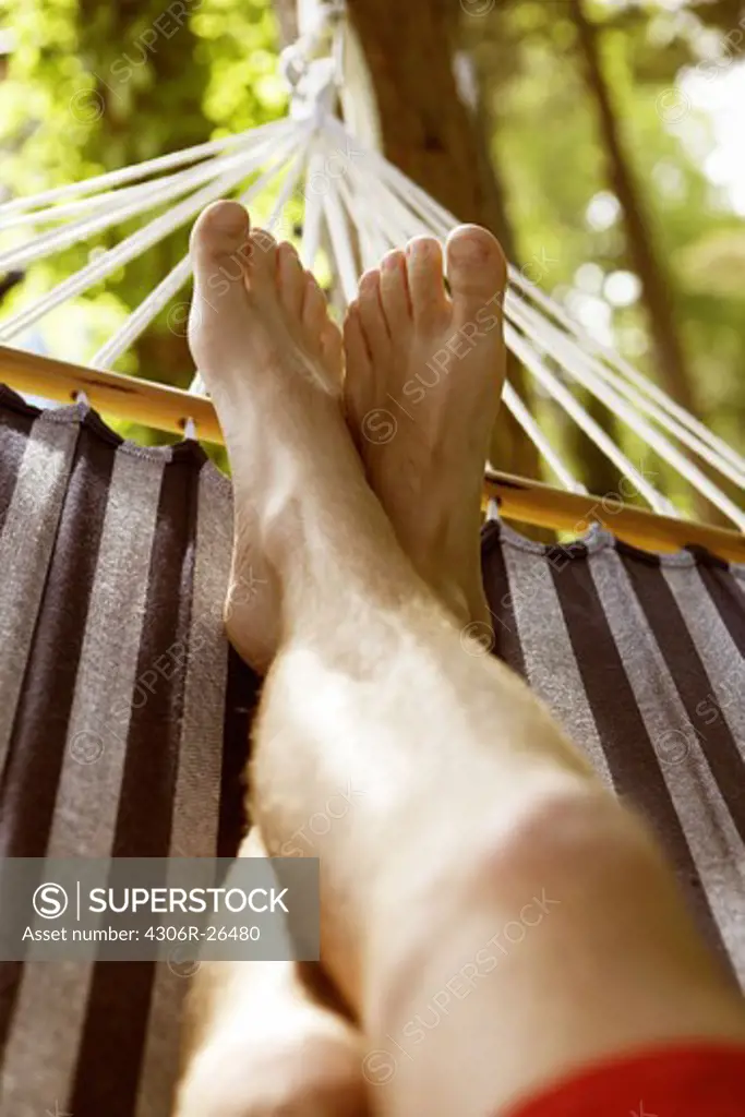 Man relaxing on hammock, low section