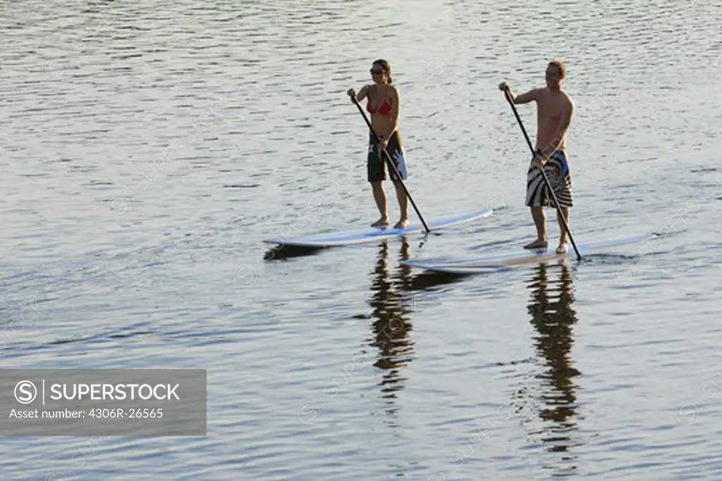 Couple stand up paddle surfing