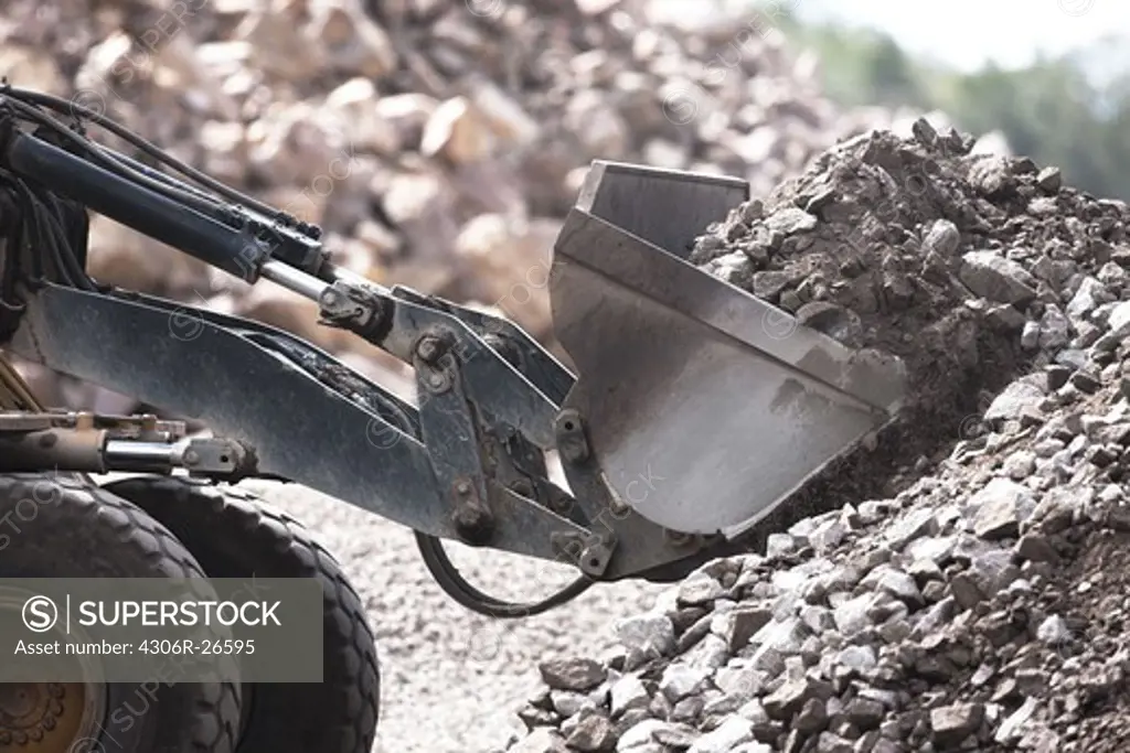 Bulldozer scoop with pile of rubble