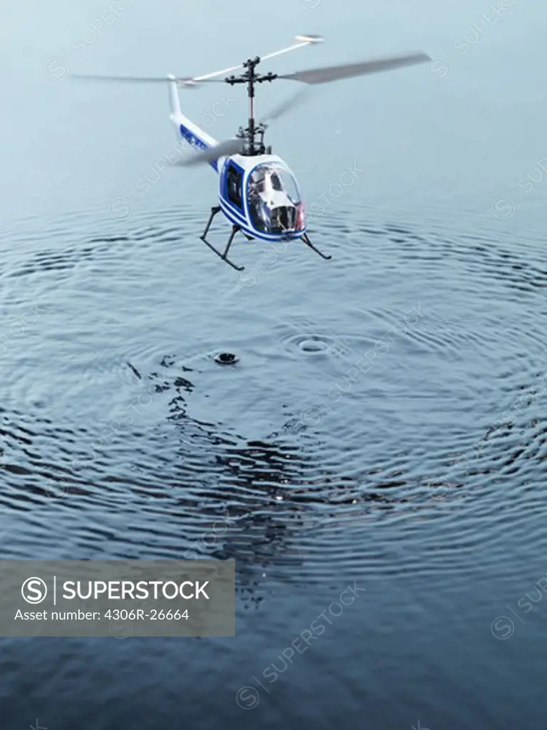 Toy helicopter above water