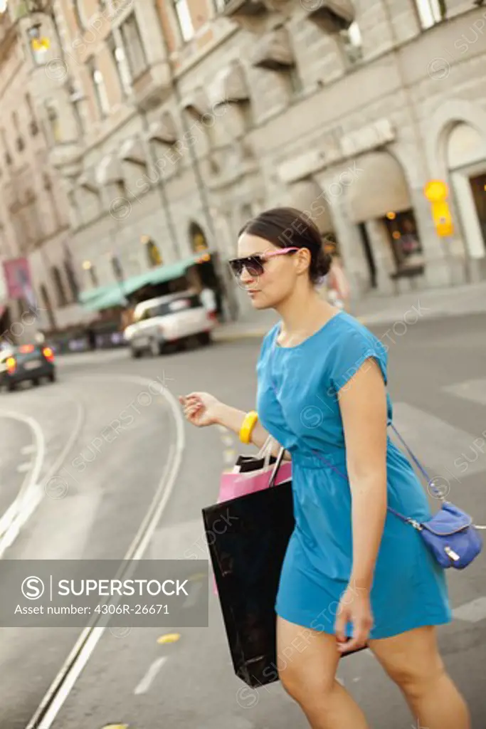 Woman walking on street with carrying shopping bags