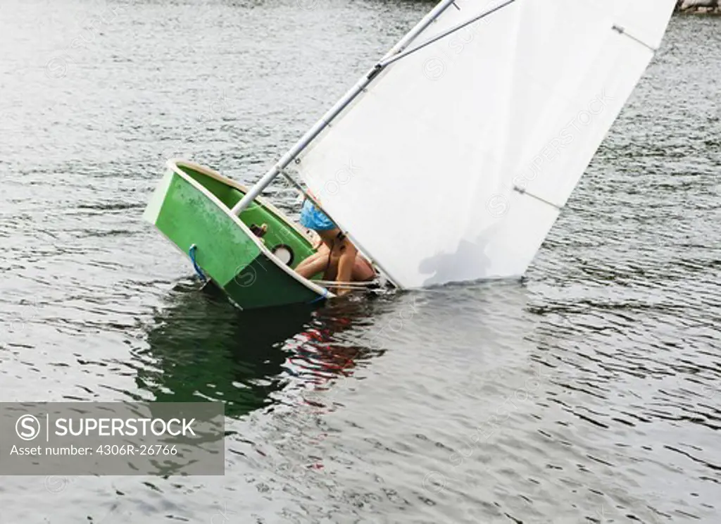 Sailing dinghy falling into water