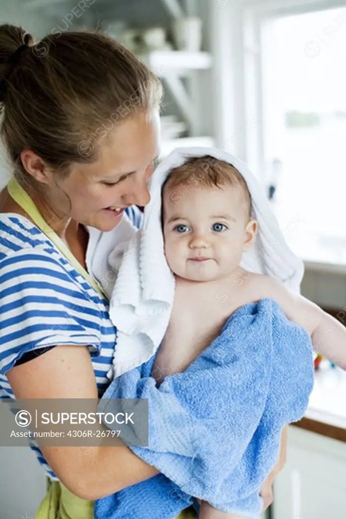 Young woman drying baby