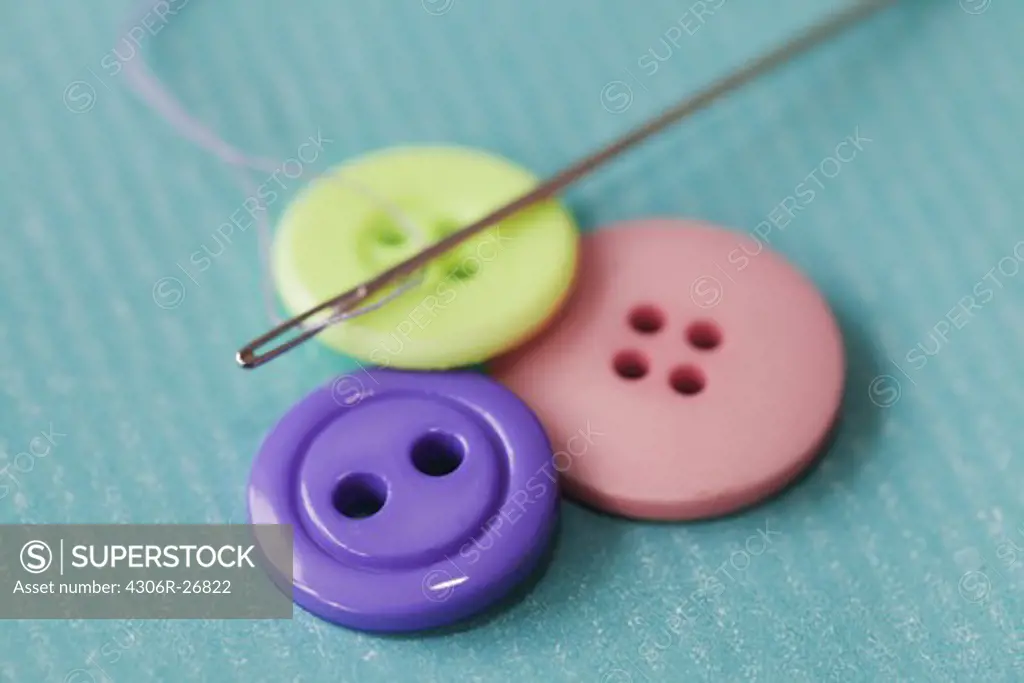 Needles on top of multi coloured buttons