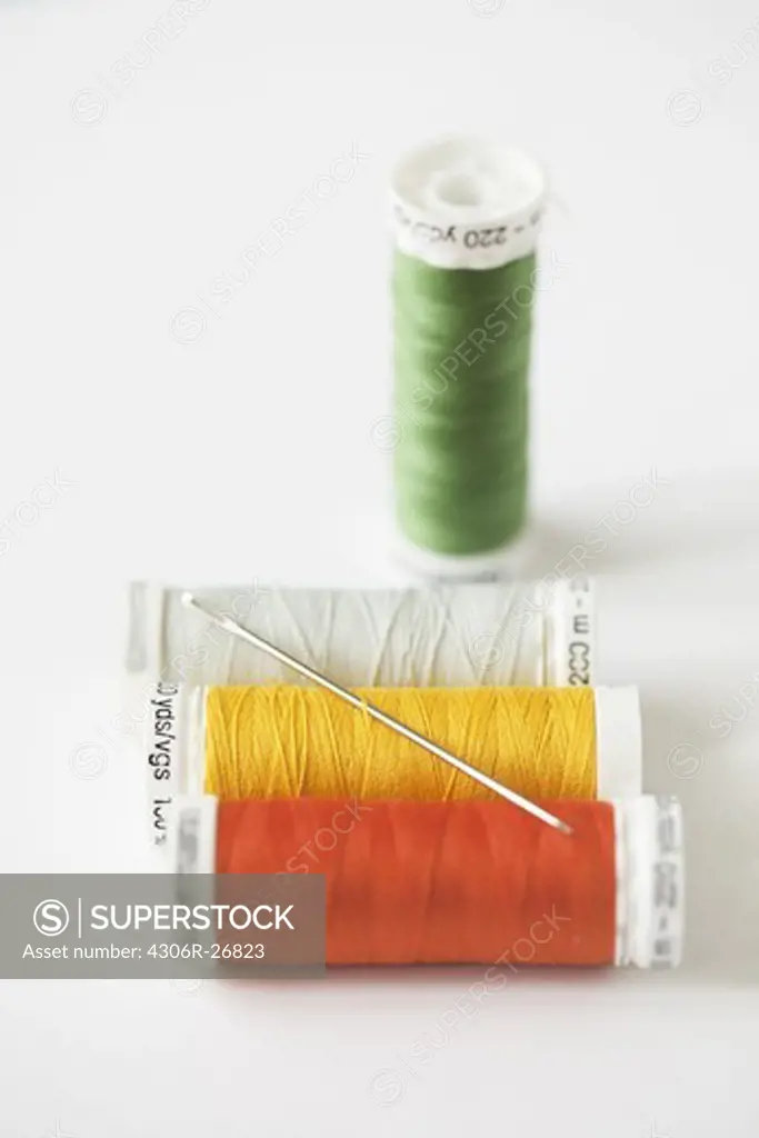 Spools of thread with needle, studio shot