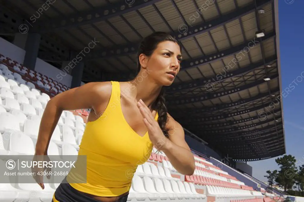 Female athlete jogging at stadium