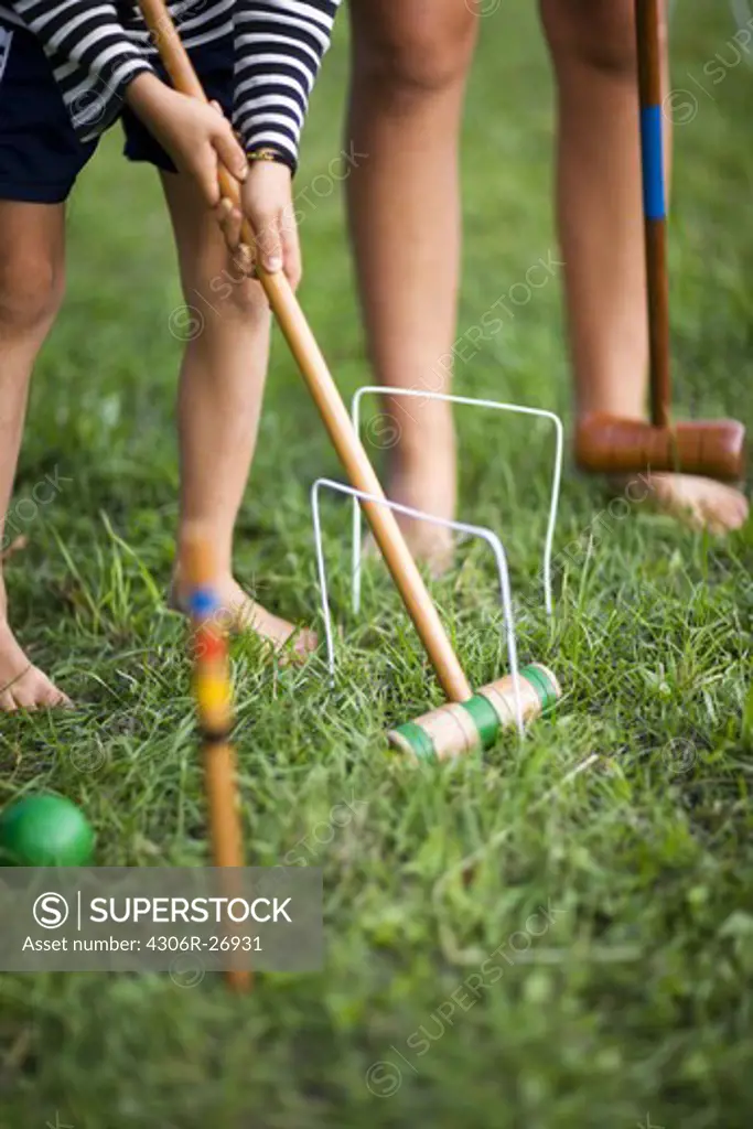 Children playing croquet, low section