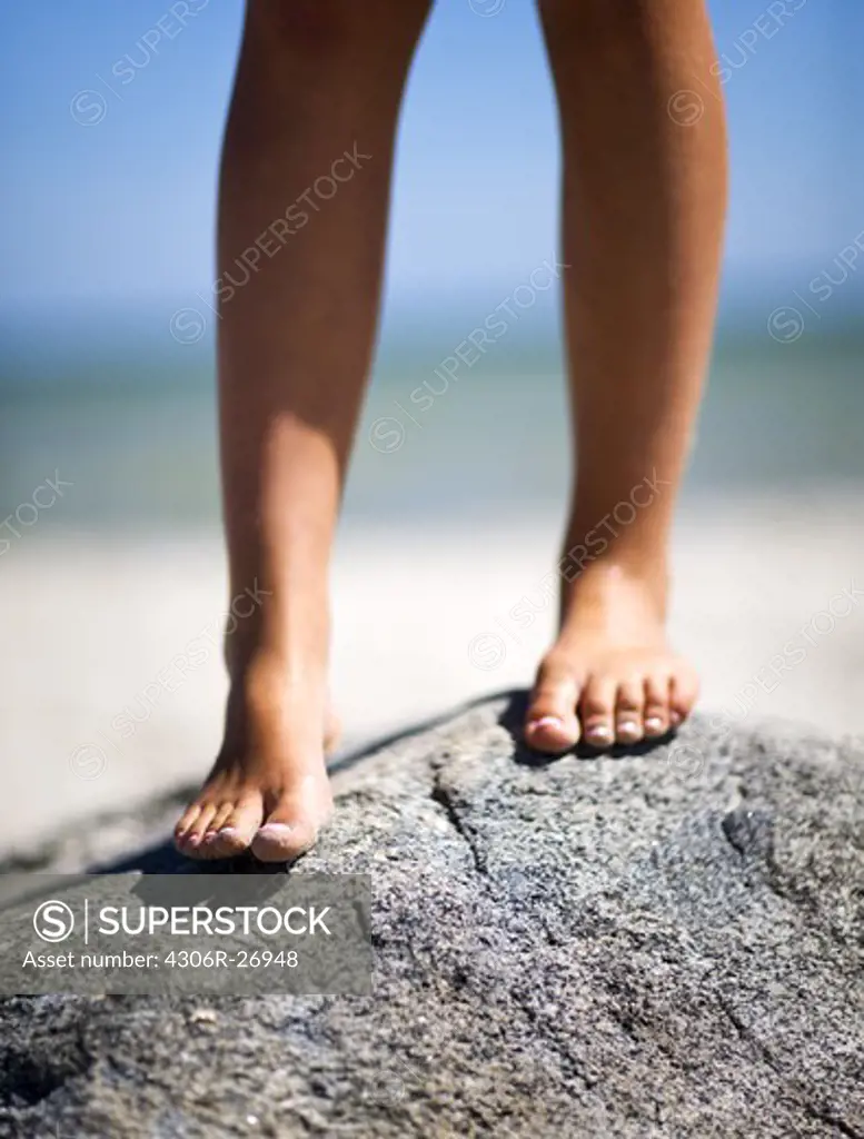 Girls barefoot on stone, close-up