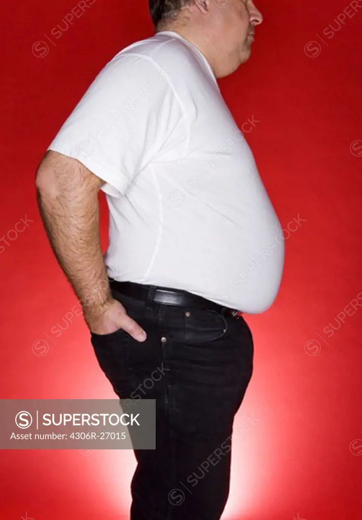 Obese man against red background