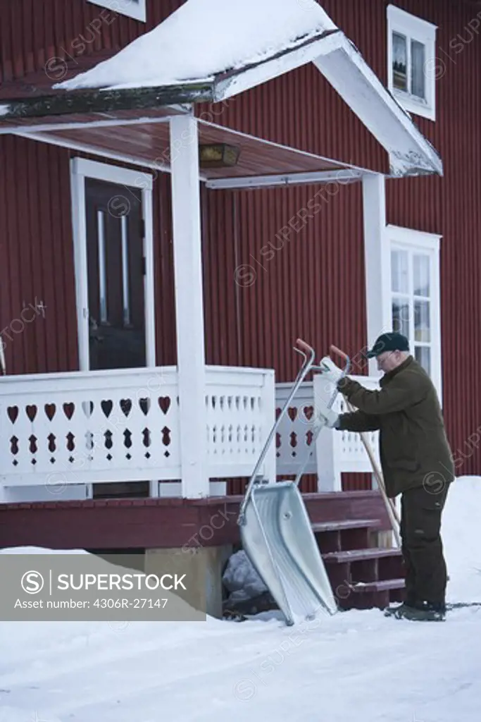 A man clearing away the snow, Sweden.