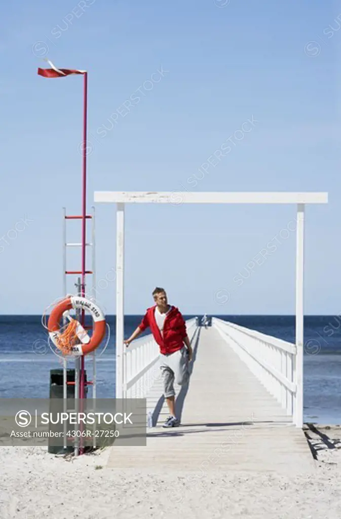 A man standing on a jetty, Malmo, Skane, Sweden.