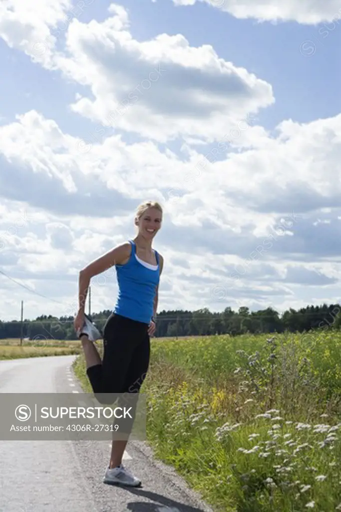 A woman doing stretching exercises, Sweden.