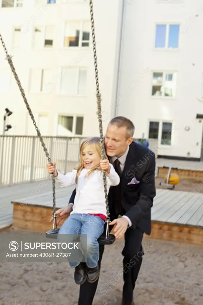Father and daughter playing in playground