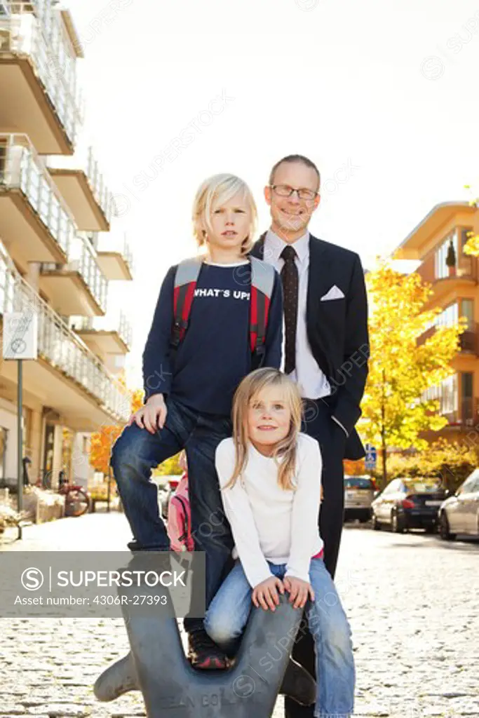 Father and children posing on street
