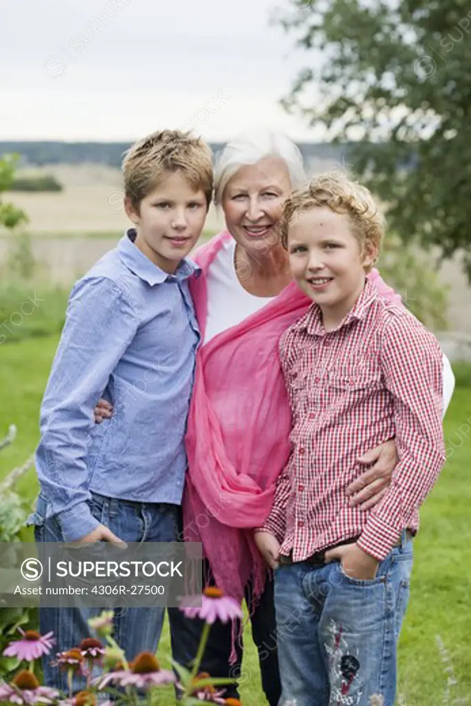 Grandmother with grandsons in garden
