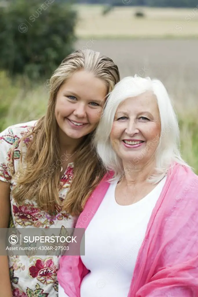 Portrait of grandmother and granddaughter smiling