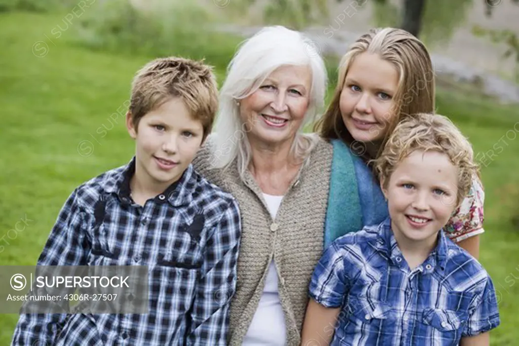Portrait of grandmother with two grandsons and granddaughter
