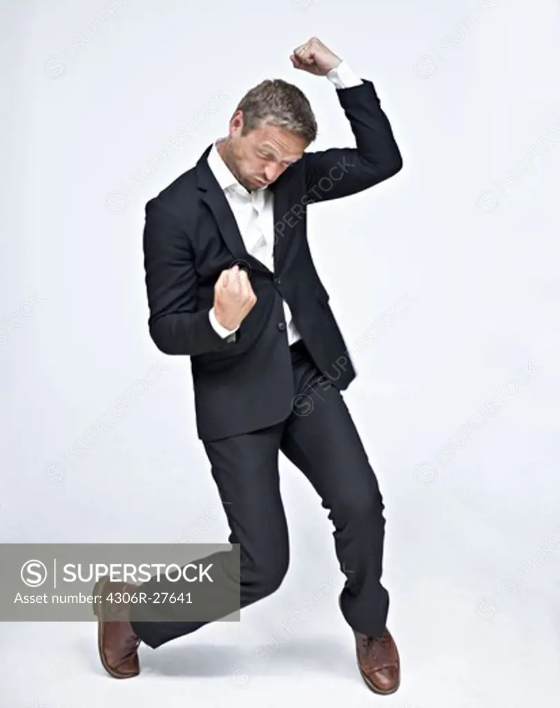 Businessman dancing and punching air