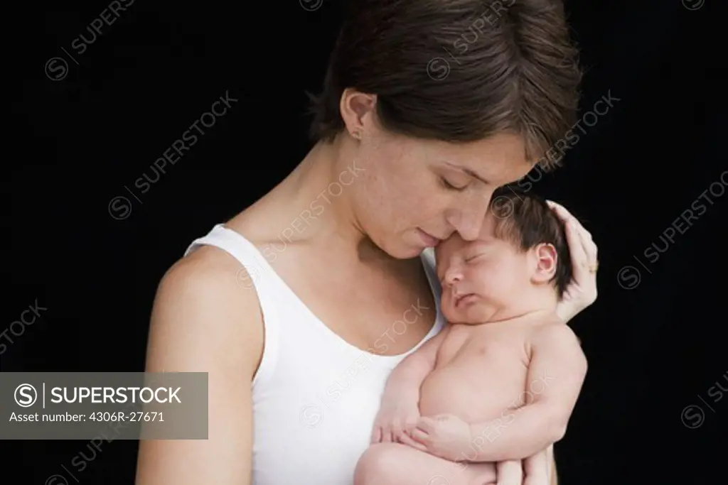 Portrait of mother with newborn baby