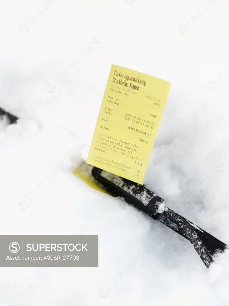 Parking ticket behind windshield wiper
