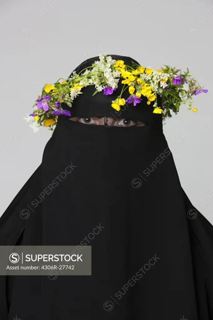 Portrait of woman wearing burka and flower wreath