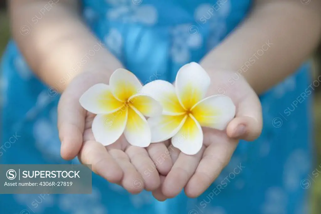 Girl holding tropical flowers
