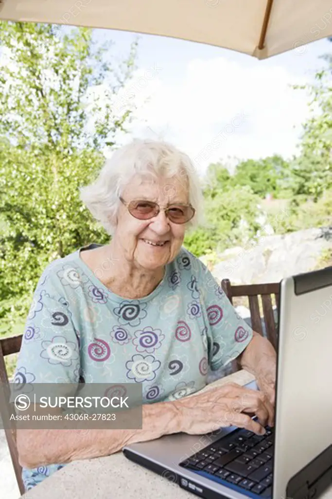Portrait of senior woman using laptop