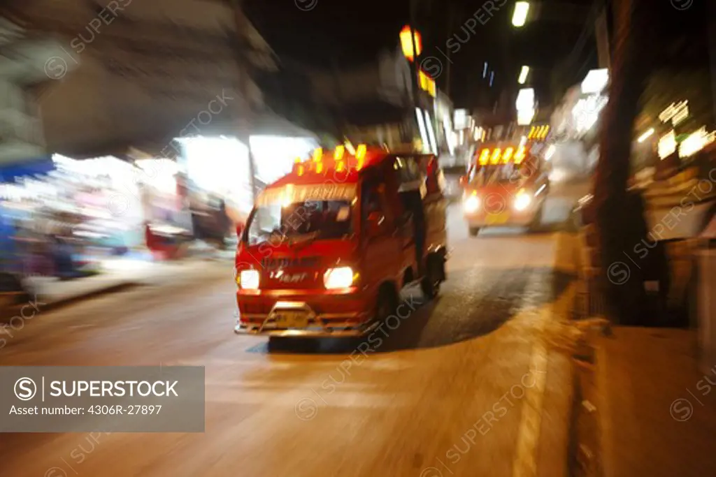 Speeding vans on main road at night