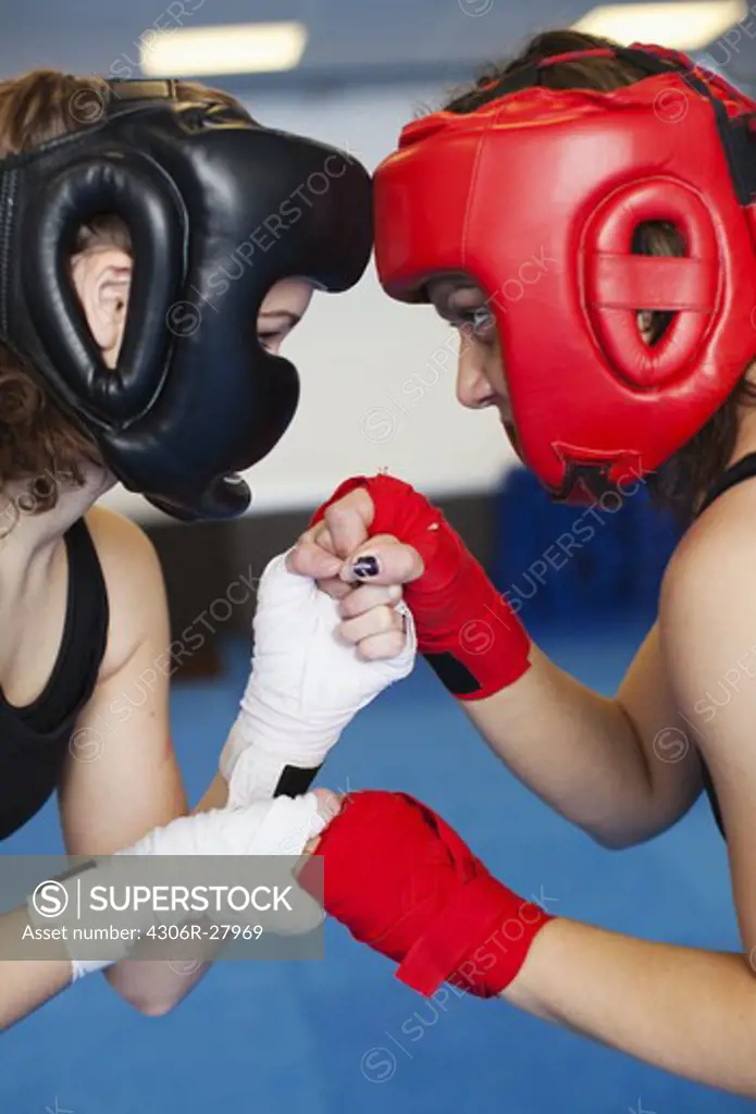 Two female kick boxers face to face