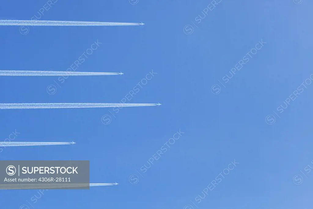 Airplanes against blue sky, directly below