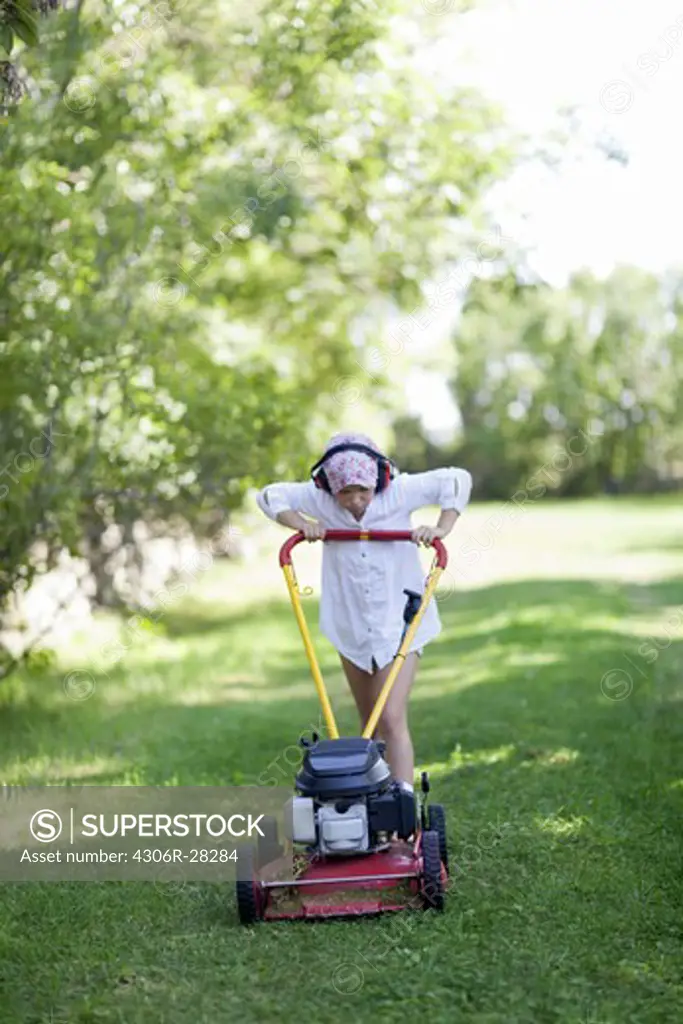 Girl mowing lawn