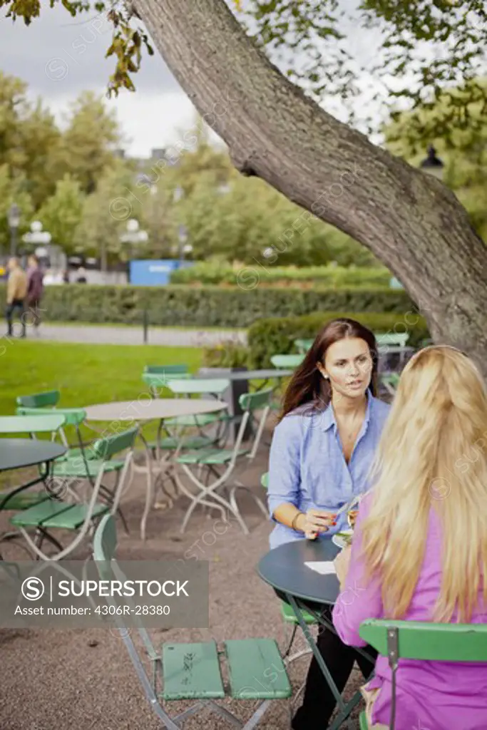 Two women sitting at outdoor cafe