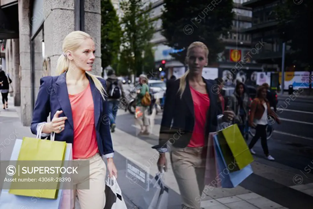 Woman with shopping bags window shopping