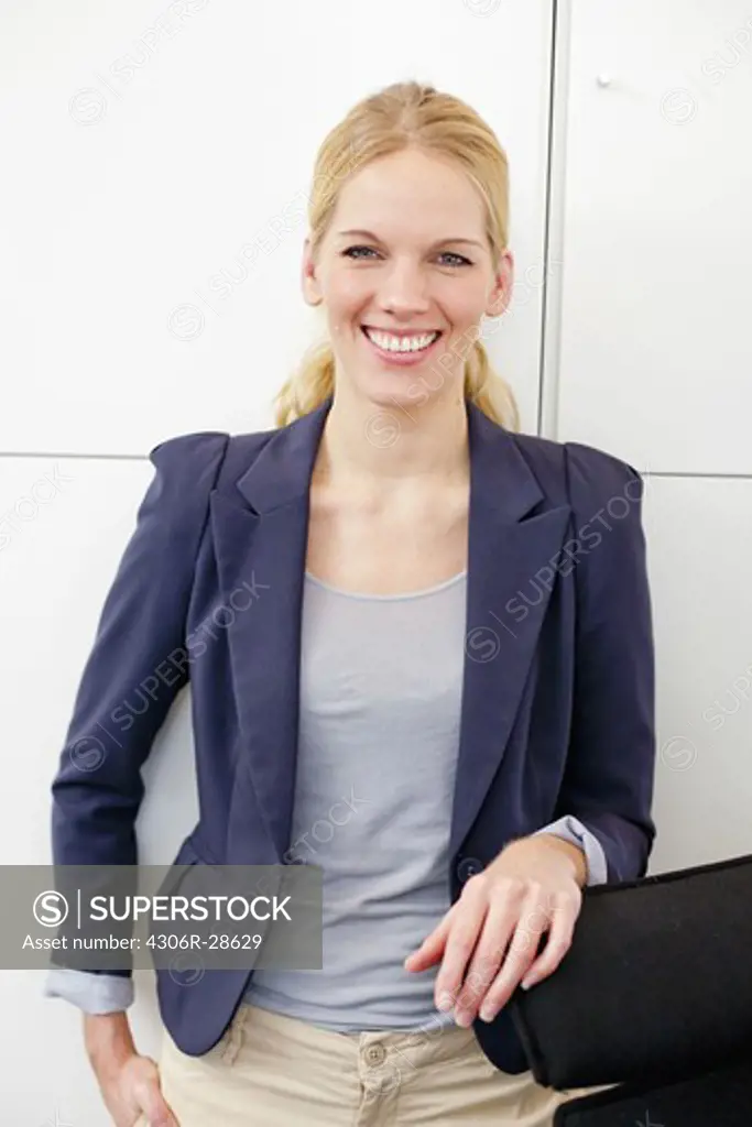 Happy businesswoman portrayed in office environment