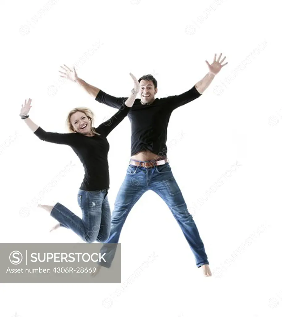 Young couple jumping together in joy