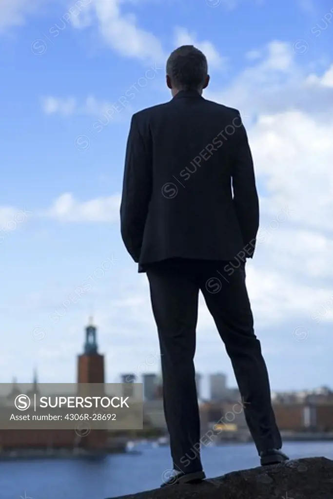 Mature man standing and looking at Stockholm City Hall