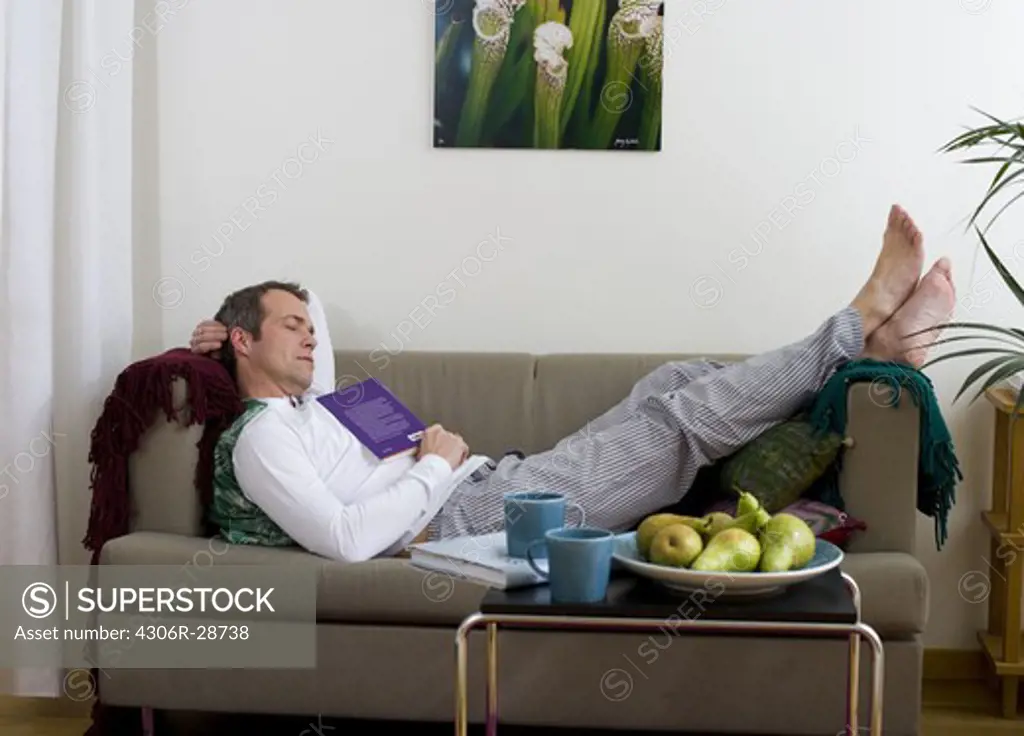 Mature man relaxing on sofa