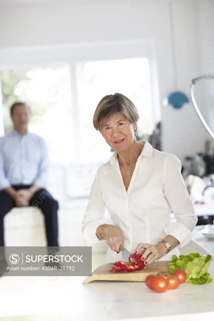 Mature woman preparing food at table
