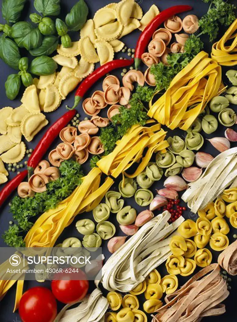 Rows of pasta, spaghetti, pepperoni, tomatoes and other ingredients