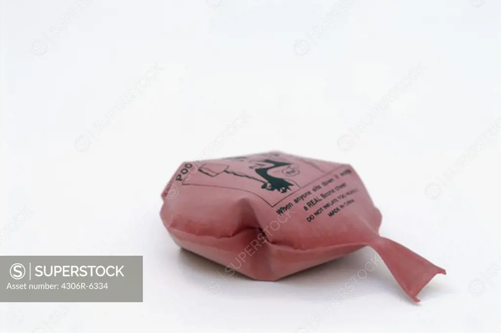 Pink whoopee cushion against white background