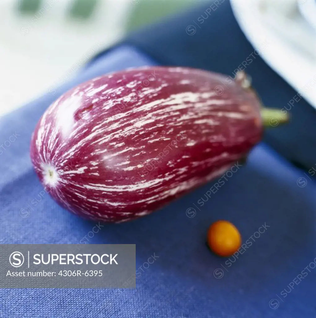 Close-up of raw aubergine on blue table