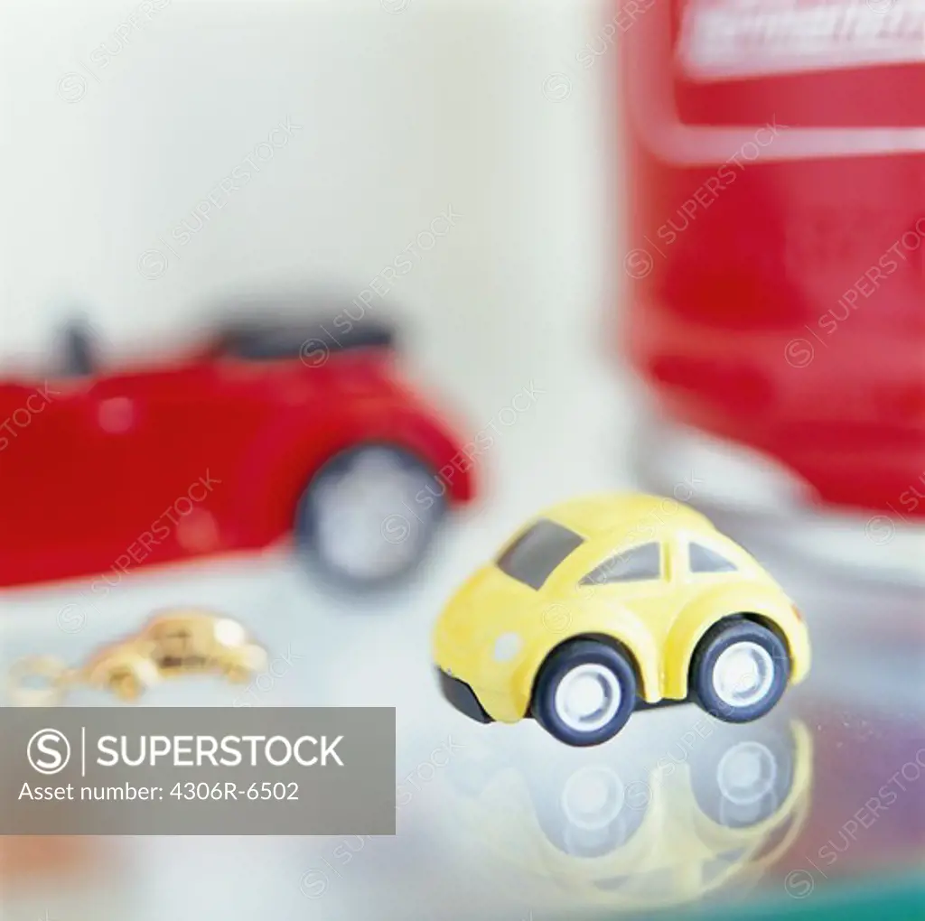 Close-up of yellow toy car on glass surface
