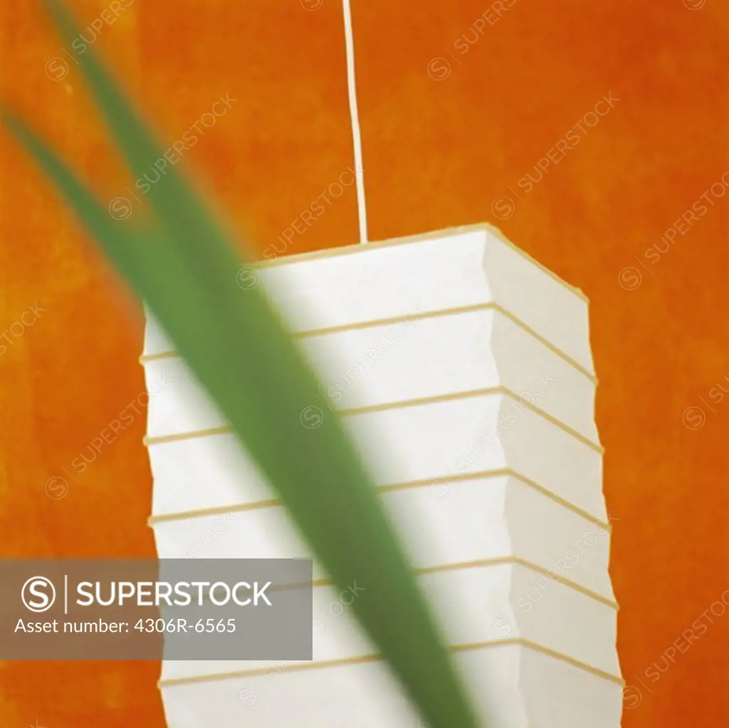 White square lamp against orange wall
