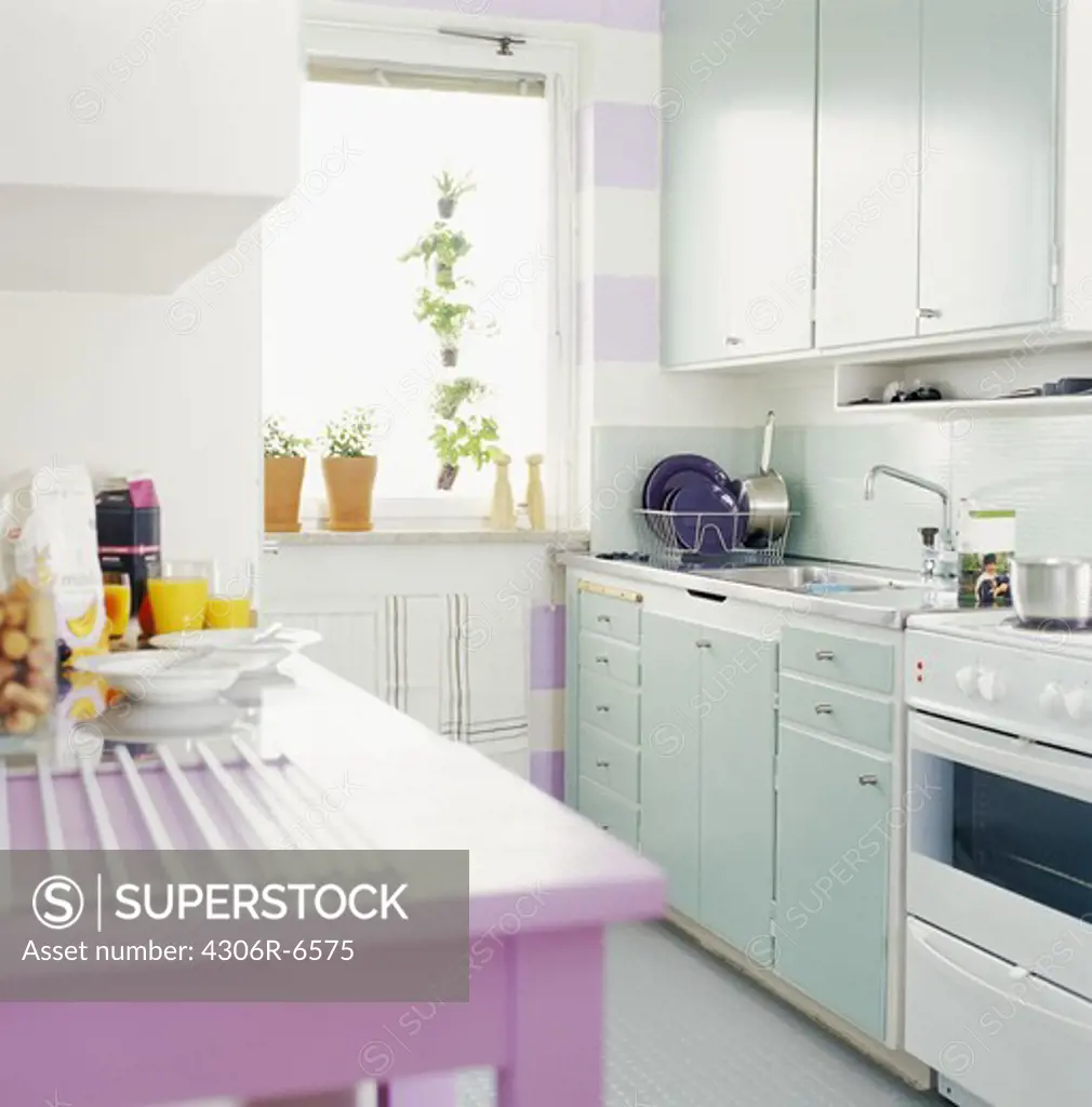 Interior of modern kitchen with utensils and food items on kitchen top