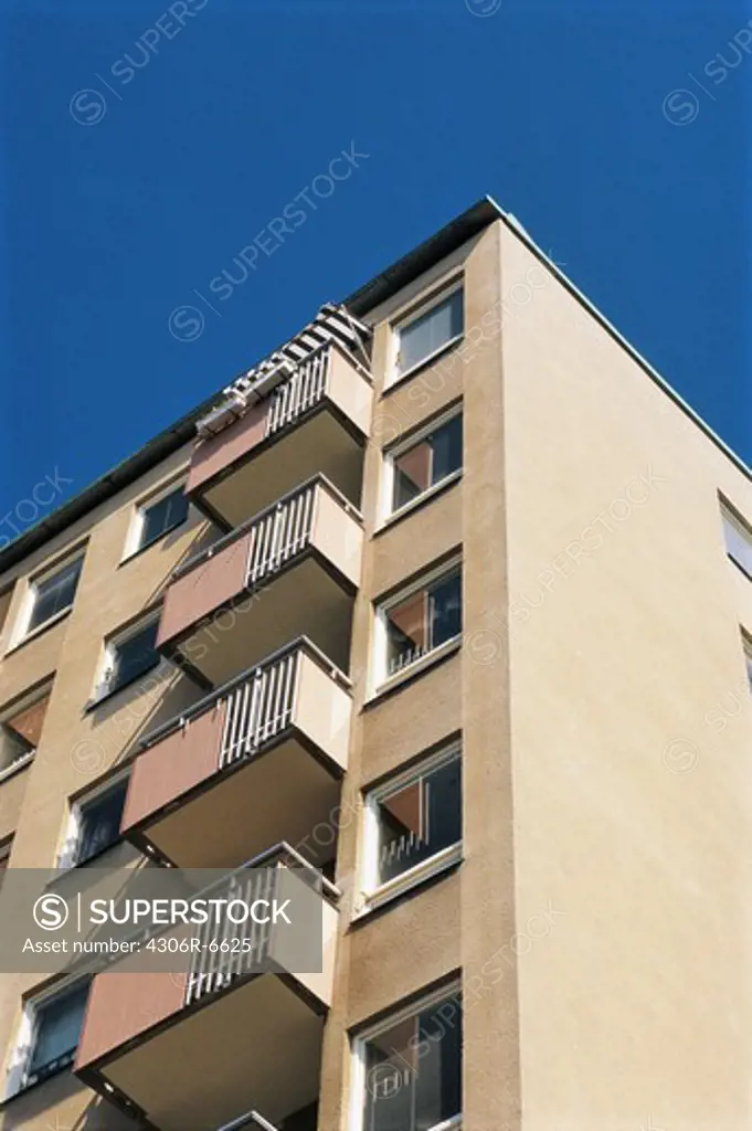 Low angle view of multi storey building against blue sky